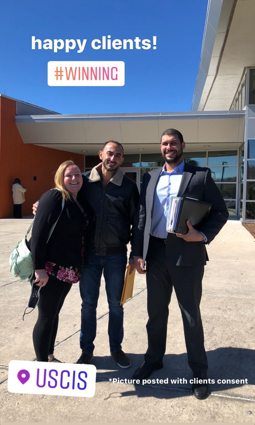 Attorney Yazen Abdin with clients outside a USCIS field office after their appointment